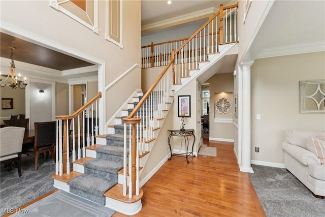 3281 Evans Way, Twinsburg, OH 44087 - stairway with wood finished floors, ornamental molding, a chandelier, ornate columns, and recessed lighting