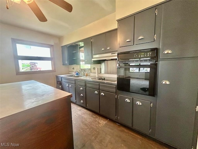 116 Euclid Pl, Marietta, OH 45750 - kitchen featuring black appliances, a ceiling fan, under cabinet range hood, concrete floors, and light countertops