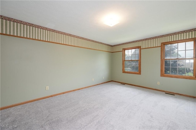 2811 Canton Rd, Uniontown, OH 44685 - spare room featuring carpet flooring and wallpapered walls