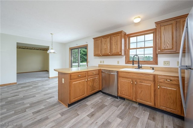 2811 Canton Rd, Uniontown, OH 44685 - kitchen featuring stainless steel appliances, a peninsula, light countertops, and light wood-style floors