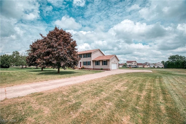 2811 Canton Rd, Uniontown, OH 44685 - colonial home with concrete driveway, an attached garage, and a front lawn