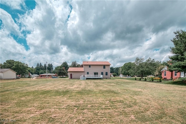 2811 Canton Rd, Uniontown, OH 44685 - view of grassy yard with a deck