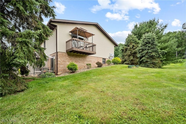 1222 Schneiders Crossing Rd NW # C, Dover, OH 44622 - rear view of property with brick siding, a balcony, and a yard