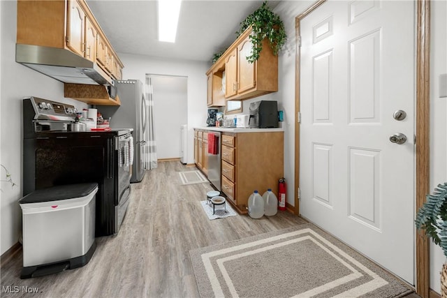 1222 Schneiders Crossing Rd NW # C, Dover, OH 44622 - kitchen featuring appliances with stainless steel finishes, under cabinet range hood, light wood-style floors, and light countertops