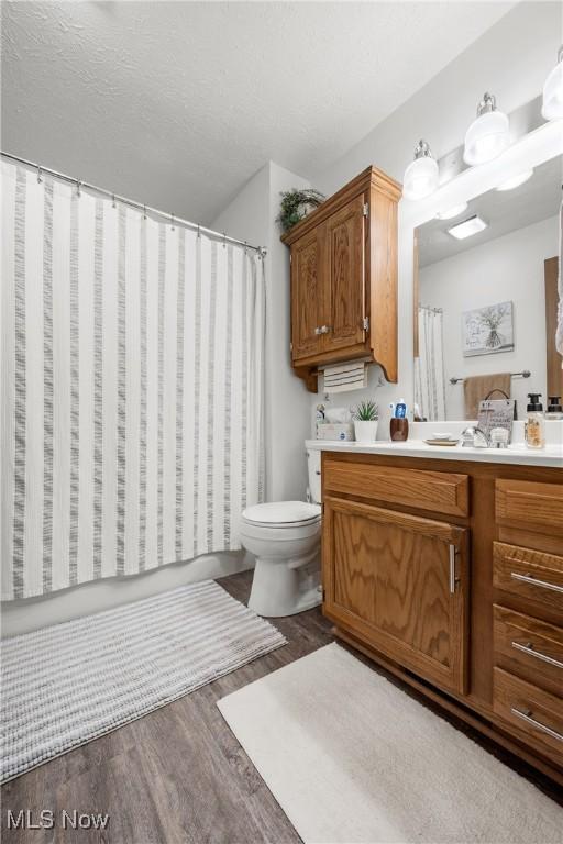 1222 Schneiders Crossing Rd NW # C, Dover, OH 44622 - bathroom featuring vanity, wood finished floors, and curtained shower