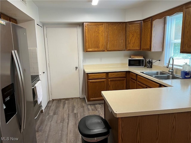 678 Highland Dr, Lodi, OH 44254 - kitchen featuring stainless steel fridge with ice dispenser, black microwave, wood finished floors, and light countertops