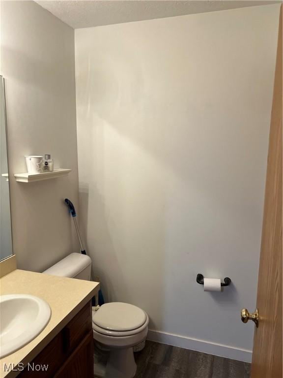 678 Highland Dr, Lodi, OH 44254 - half bathroom featuring vanity and wood finished floors