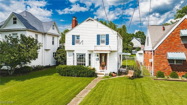 1055 W Virginia Ave, Parkersburg, WV 26104 - view of front of home with a front yard and a chimney