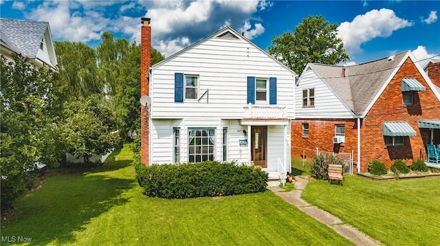 1055 W Virginia Ave, Parkersburg, WV 26104 - view of front facade with a front yard and a chimney