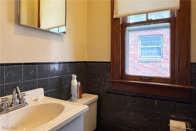 1055 W Virginia Ave, Parkersburg, WV 26104 - bathroom with tile walls, vanity, and wainscoting