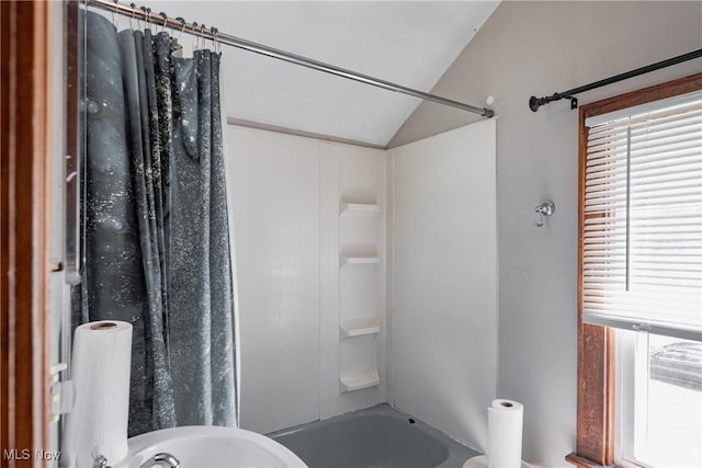 1055 W Virginia Ave, Parkersburg, WV 26104 - bathroom featuring vaulted ceiling and bathtub / shower combination