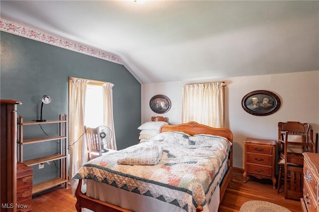 1055 W Virginia Ave, Parkersburg, WV 26104 - bedroom featuring lofted ceiling and wood finished floors