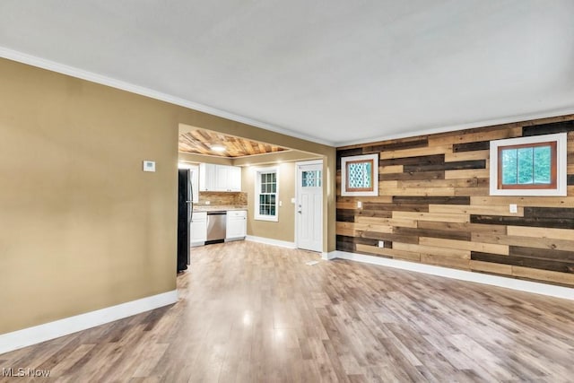 2968 Hayne Rd, Akron, OH 44312 - unfurnished living room with crown molding, light wood finished floors, and wooden walls