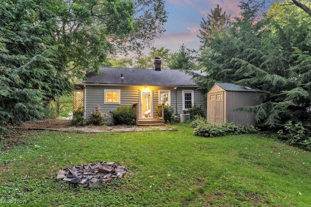 2968 Hayne Rd, Akron, OH 44312 - view of front facade with a storage shed, a front yard, and a chimney