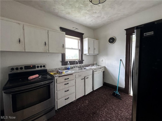 625 Main St, Caldwell, OH 43724 - kitchen featuring appliances with stainless steel finishes, white cabinetry, a textured ceiling, and dark colored carpet