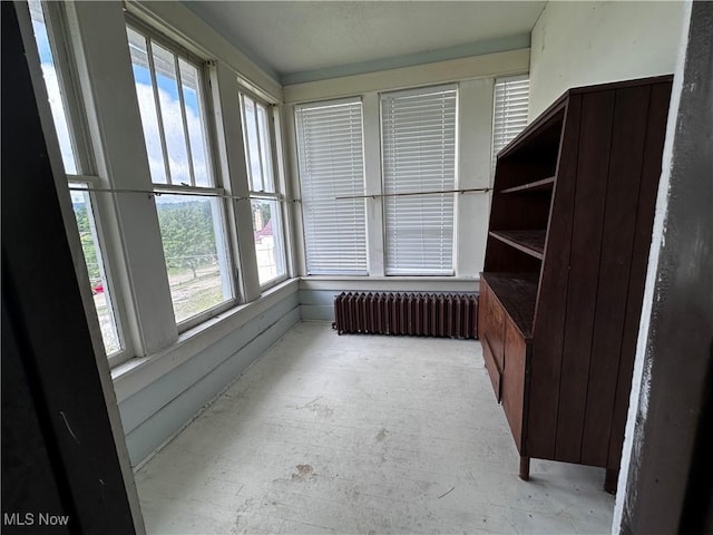 625 Main St, Caldwell, OH 43724 - unfurnished sunroom featuring radiator heating unit