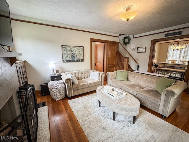 2208 Oak St, Parkersburg, WV 26101 - living area with stairway, hardwood / wood-style floors, a textured ceiling, and a chandelier