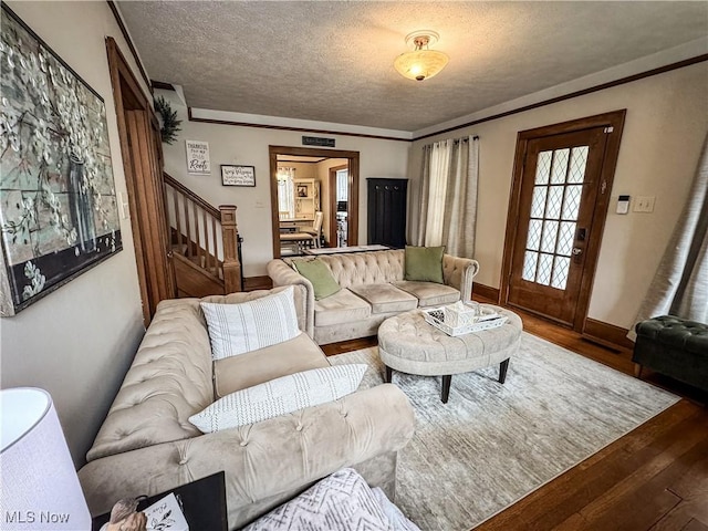 2208 Oak St, Parkersburg, WV 26101 - living room featuring wood finished floors, stairs, and a textured ceiling