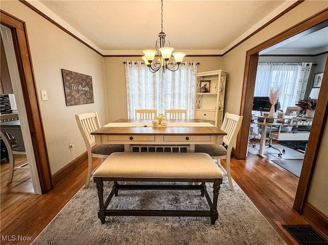 2208 Oak St, Parkersburg, WV 26101 - dining space with a chandelier, dark wood-style flooring, and ornamental molding