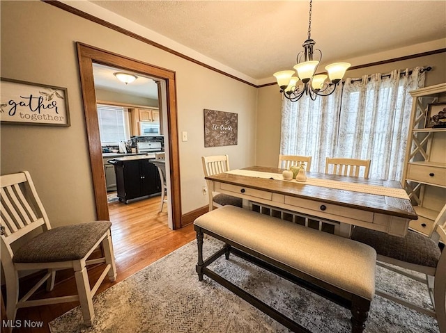 2208 Oak St, Parkersburg, WV 26101 - dining area with a chandelier, light wood-style flooring, and ornamental molding