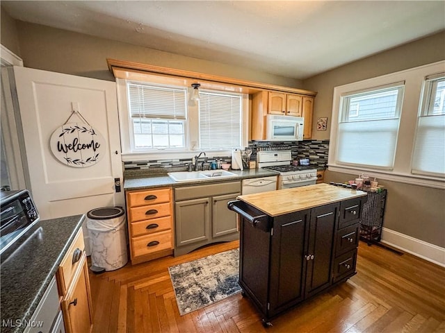 2208 Oak St, Parkersburg, WV 26101 - kitchen with white appliances, backsplash, healthy amount of natural light, and a center island
