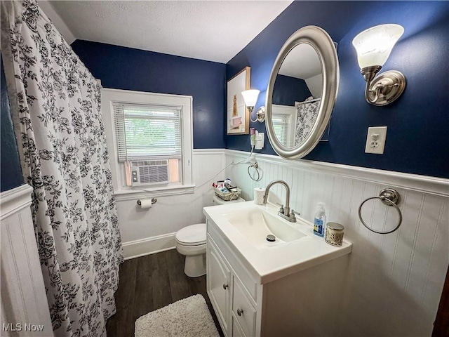 2208 Oak St, Parkersburg, WV 26101 - bathroom featuring wainscoting, cooling unit, vanity, wood finished floors, and a shower with curtain