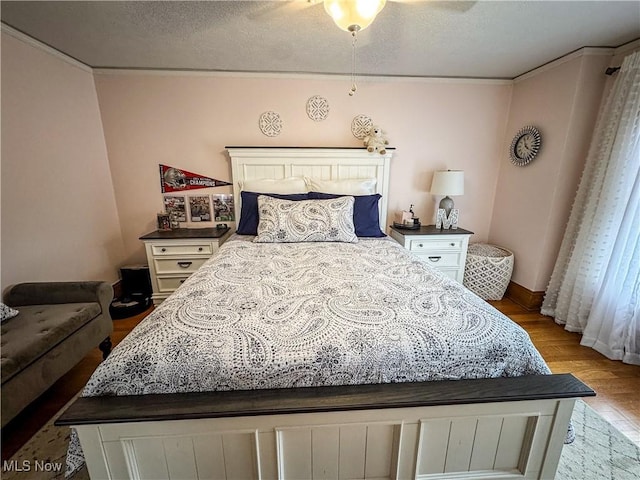 2208 Oak St, Parkersburg, WV 26101 - bedroom featuring light wood-style floors, a textured ceiling, ornamental molding, and ceiling fan