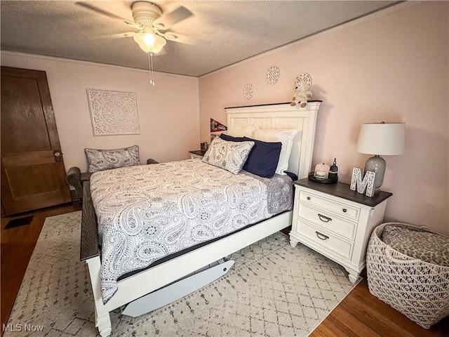 2208 Oak St, Parkersburg, WV 26101 - bedroom featuring wood finished floors, a textured ceiling, a ceiling fan, and ornamental molding