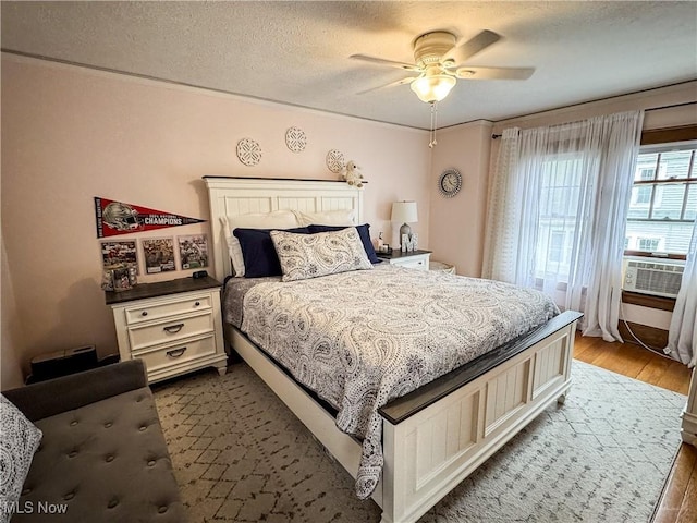 2208 Oak St, Parkersburg, WV 26101 - bedroom with wood finished floors, cooling unit, a textured ceiling, and ceiling fan