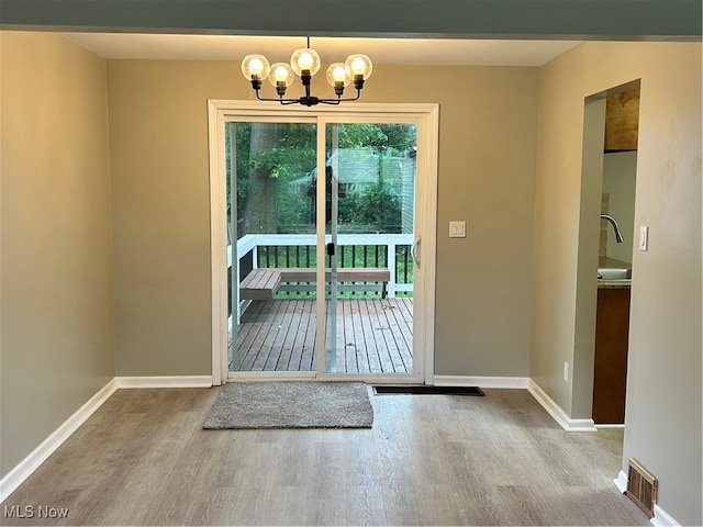4514 Lilac Rd, South Euclid, OH 44121 - entryway with wood finished floors and a chandelier