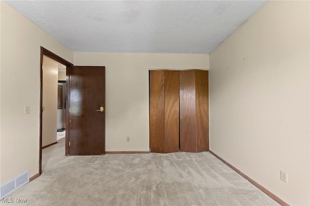 1781 Old Forge Rd, Mogadore, OH 44260 - unfurnished bedroom featuring light colored carpet, a closet, and a textured ceiling