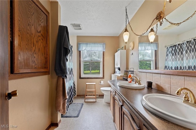 1781 Old Forge Rd, Mogadore, OH 44260 - full bathroom with healthy amount of natural light, double vanity, a textured ceiling, and a shower with curtain