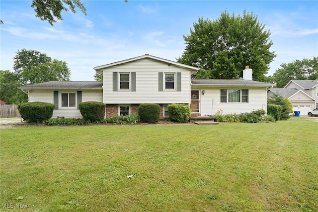 1781 Old Forge Rd, Mogadore, OH 44260 - split level home with a front yard and a chimney