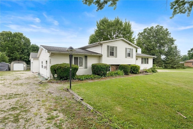 1781 Old Forge Rd, Mogadore, OH 44260 - tri-level home with an outdoor structure, a front yard, gravel driveway, and a detached garage