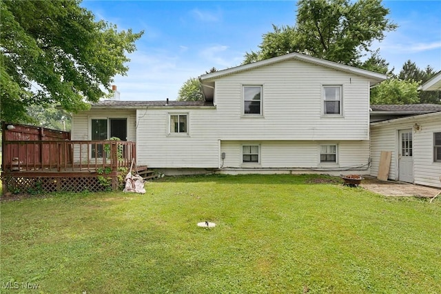 1781 Old Forge Rd, Mogadore, OH 44260 - rear view of house featuring an outdoor fire pit, a wooden deck, and a lawn