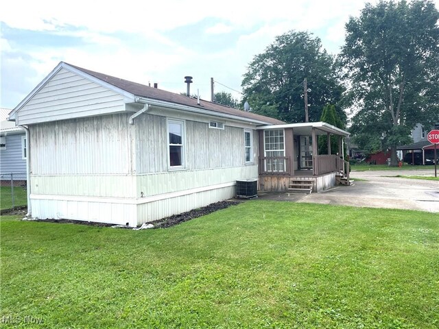 310 Jackson St, Minerva, OH 44657 - rear view of house featuring a yard and covered porch