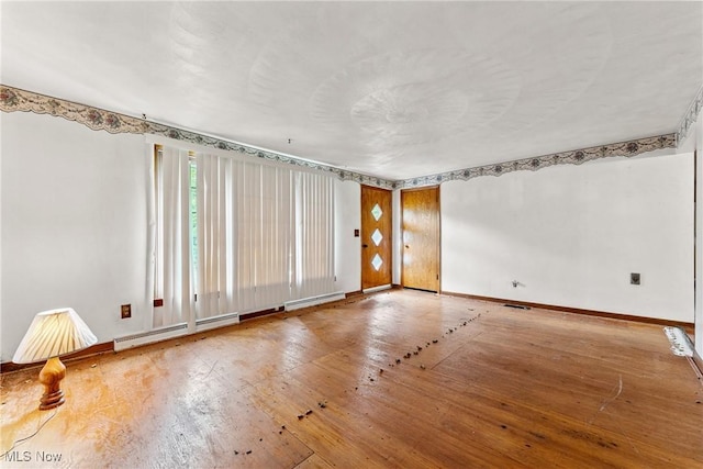 4524 Sherer Ave SW, Canton, OH 44706 - unfurnished room with wood-type flooring and a baseboard heating unit