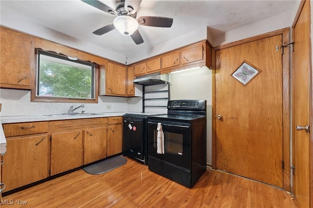 4524 Sherer Ave SW, Canton, OH 44706 - kitchen with black electric range, under cabinet range hood, brown cabinetry, and light countertops