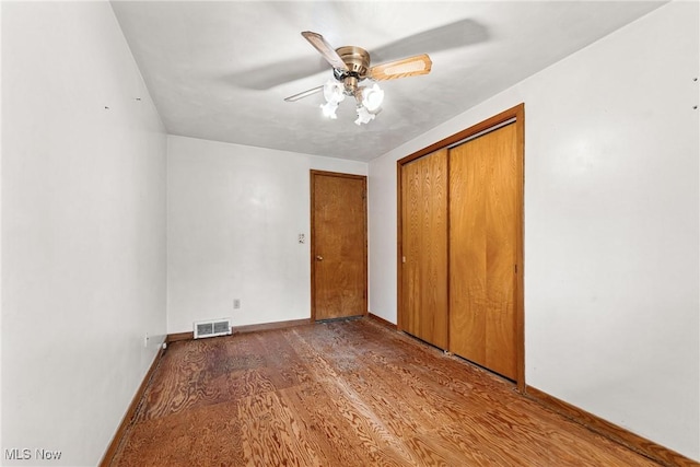 4524 Sherer Ave SW, Canton, OH 44706 - unfurnished bedroom with wood finished floors, ceiling fan, and a closet