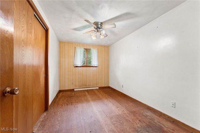4524 Sherer Ave SW, Canton, OH 44706 - unfurnished room with baseboard heating, wood finished floors, and ceiling fan