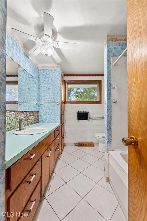 4524 Sherer Ave SW, Canton, OH 44706 - full bath with vanity, tile walls, tile patterned flooring, a ceiling fan, and shower / bath combination