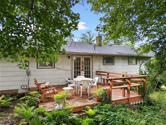 4524 Sherer Ave SW, Canton, OH 44706 - back of property with a wooden deck, french doors, a chimney, outdoor dining space, and roof with shingles