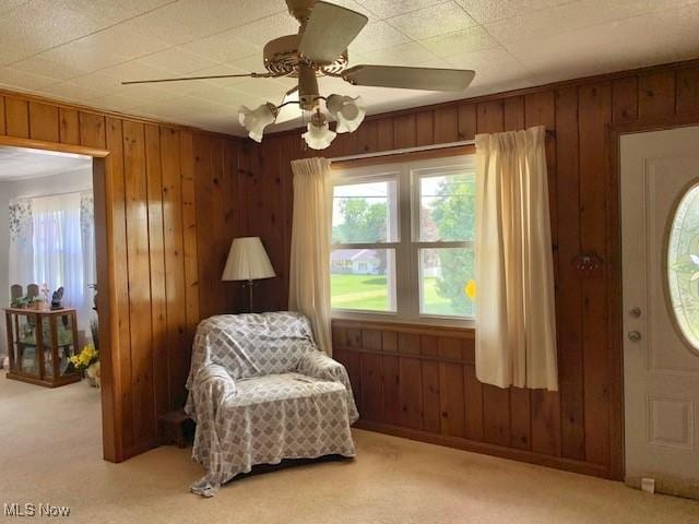62 Township Road 245, Toronto, OH 43964 - sitting room featuring light carpet, wood walls, plenty of natural light, and ceiling fan