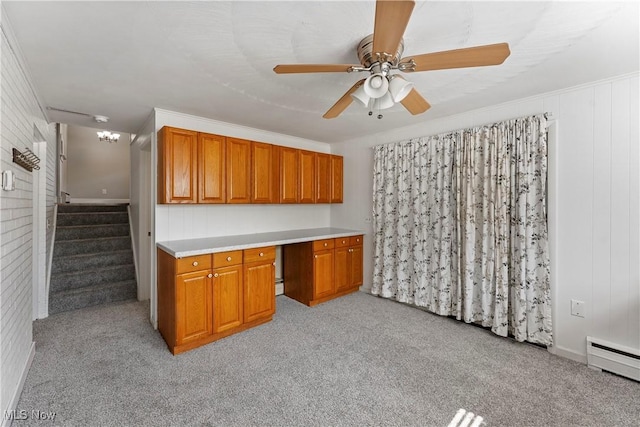2615 Daffodil St NE, Canton, OH 44705 - kitchen featuring a baseboard radiator, brown cabinets, light carpet, ceiling fan, and light countertops