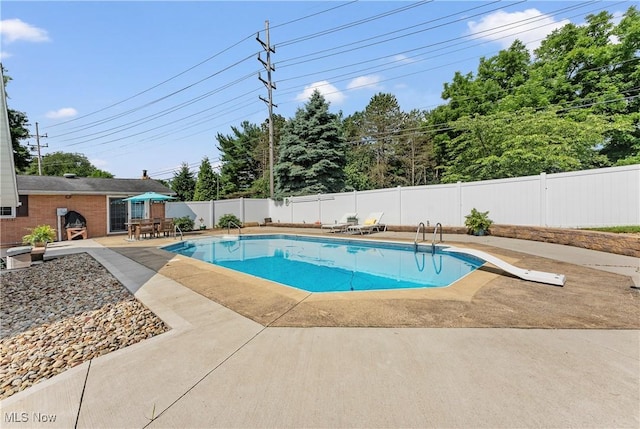 2615 Daffodil St NE, Canton, OH 44705 - view of pool featuring a patio, a fenced backyard, and a diving board