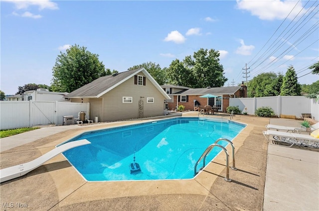 2615 Daffodil St NE, Canton, OH 44705 - view of pool with a patio area, a fenced backyard, a diving board, and a gate