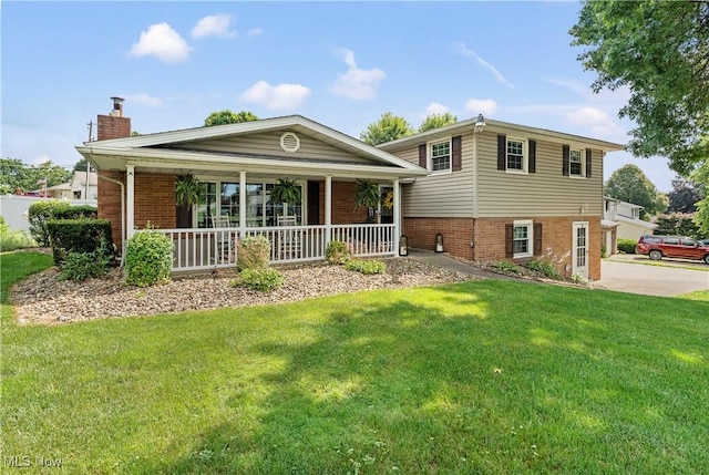 2615 Daffodil St NE, Canton, OH 44705 - rear view of property with brick siding, a chimney, a porch, and a lawn