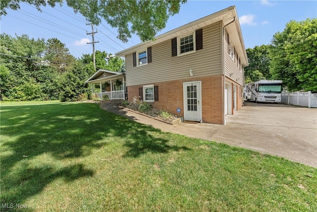 2615 Daffodil St NE, Canton, OH 44705 - back of property with brick siding, concrete driveway, and an attached garage