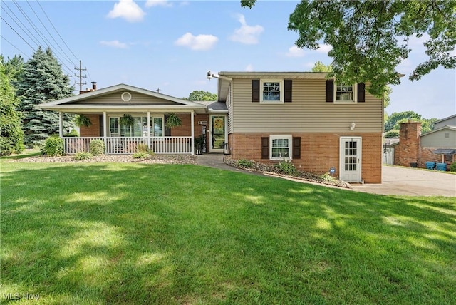 2615 Daffodil St NE, Canton, OH 44705 - split level home featuring brick siding, covered porch, and a front yard