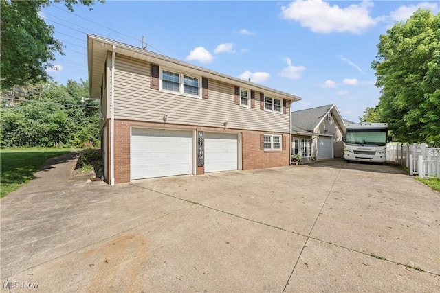 2615 Daffodil St NE, Canton, OH 44705 - view of front of house featuring brick siding, concrete driveway, and a garage
